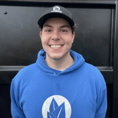 atkinsonlandscaping staff kyle in a blue hoodie against a black background